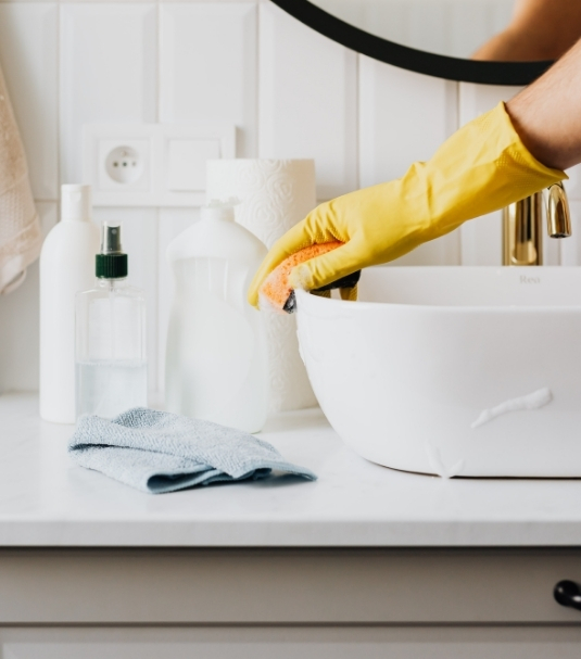 Professional cleaner doing deep cleaning in Accokeek, MD, scrubbing inside oven and kitchen surfaces